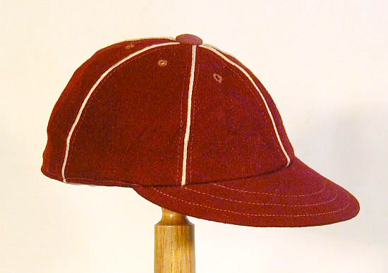 This antique baseball cap is made of maroon colored wool with a soft and